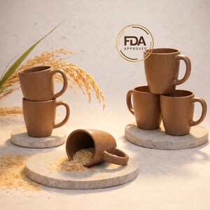 May include: A collection of brown mugs, some stacked and others arranged on stone coasters. One mug is tipped over, spilling rice. The FDA Approved seal is visible. The mugs have a simple, rounded design.