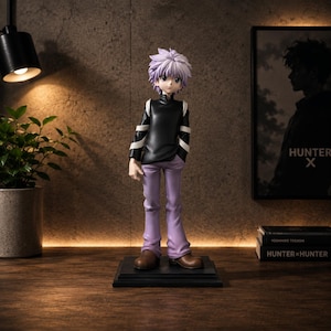 May include: A standing anime character figurine featuring spiky light purple hair, a black long-sleeved shirt with white arm bands, light purple trousers, and brown shoes. The figure is mounted on a square black base and depicts a young person.