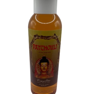 May include: A clear plastic bottle filled with amber-colored liquid, topped with a white cap. The label features a brown branch border, the red text PATCHOULI COLOGNE, a golden Buddha illustration, and the text Crusellas 33 FL. OZ. (974ml).
