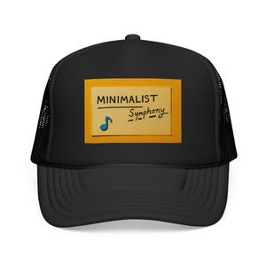 May include: Black trucker cap with a mesh back and a curved peak. The front displays a yellow rectangle with the words "MINIMALIST Symphony" and a blue musical note.