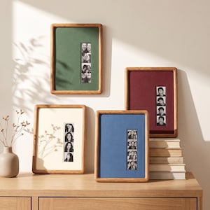 Peut inclure: Quatre cadres photo rectangulaires en bois aux coins arrondis, chacun doté d'un passe-partout coloré en vert, crème, bleu ou bordeaux. Chaque cadre contient une bande verticale de portraits en noir et blanc centrée sur le passe-partout.