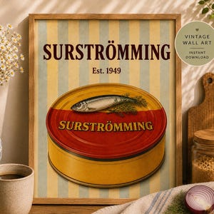 May include: A framed wall art print featuring a yellow and light blue striped background with the text SURSTRÖMMING and Est. 1949. The central illustration depicts a round yellow and red tin of fish with a single fish and dill sprig on top.