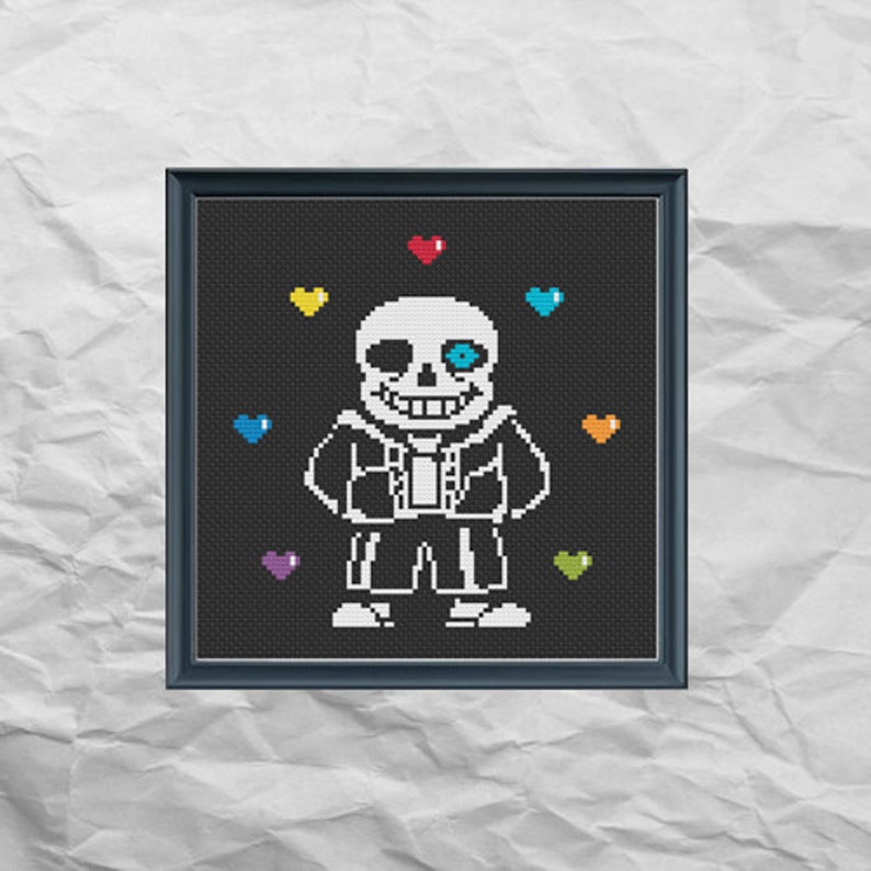May include: A black and white pixel art cross-stitch pattern of Sans from the video game Undertale. Sans is surrounded by colorful hearts.