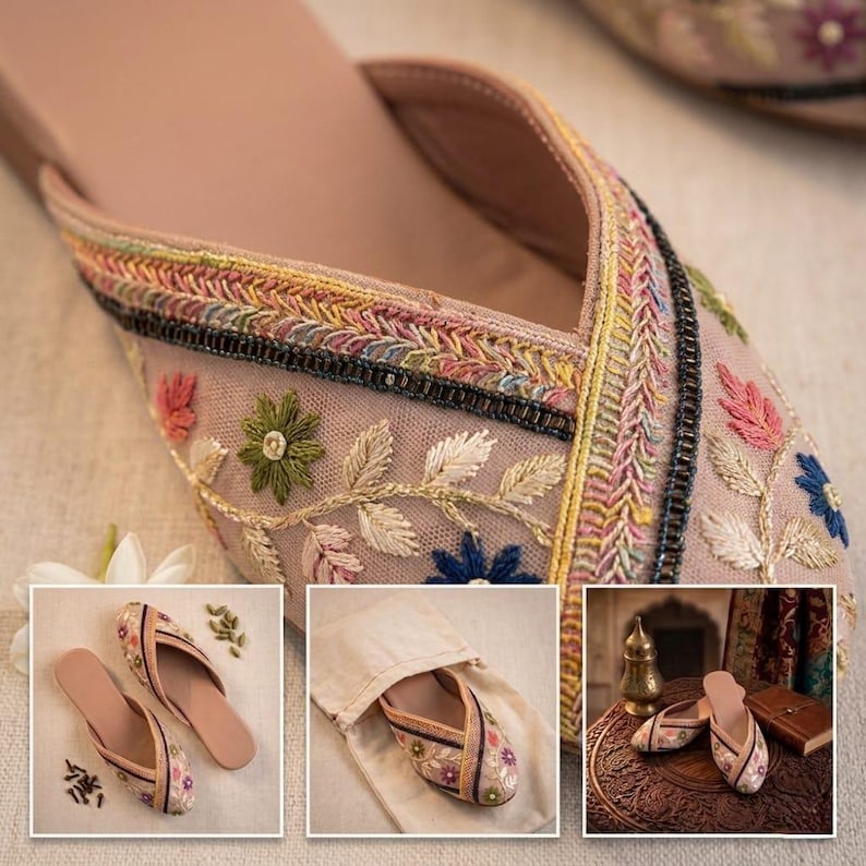 May include: Close-up of a pair of embroidered slip-on shoes. The shoes feature a light pink mesh upper with colorful floral embroidery and a decorative trim. Additional images show the shoes in a bag and on a table.