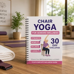 May include: A spiral-bound book titled "Chair Yoga for Seniors Wellness" with a woman demonstrating a yoga pose. The cover includes the text "30 Day Challenge" and lists benefits like strength and flexibility. A rolled white towel and yoga strap are in the foreground.