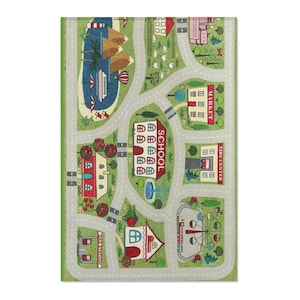 May include: A rectangular play rug with a town map design. The rug features roads, buildings, a lake with boats, and a Ferris wheel. Buildings include a school, market, and gas station. The rug is primarily green, gray, red, and white.