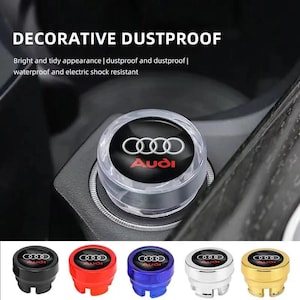 May include: A white ceramic mug with a black handle and the text "But First, Coffee" in a handwritten style. The mug is on a white surface. The mug is approximately 4 inches tall.