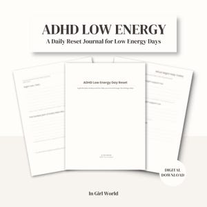 May include: A white journal titled "ADHD Low Energy" with the subtitle "A Daily Reset Journal for Low Energy Days." The journal is open, revealing lined pages. The words "DIGITAL DOWNLOAD" are in the lower right corner. The brand name "In Girl World" is at the bottom.