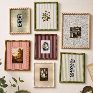 May include: A gallery wall arrangement of seven rectangular picture frames featuring various textures and colors, including green, brown, and cream beaded or rope-style borders, displaying diverse photographs, botanical prints, and patterned backgrounds.