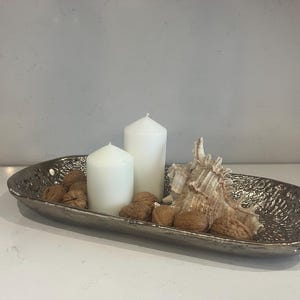 May include: A set of three ceramic mugs with a speckled, matte finish. The mugs are in shades of cream, light gray, and dark gray. Each mug has a simple, minimalist design and a rounded handle.