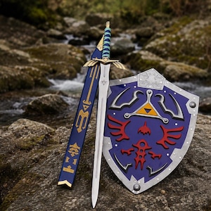 Könnte beinhalten: Ein silberfarbenes Schwert mit einem blau-türkis umwickelten Griff und goldenem Parierstange, begleitet von einer passenden blauen Scheide mit goldenen Details und einem blauen Schild mit silbernem Rand, rotem Vogel-Emblem und gelbem Dreieckswappen.