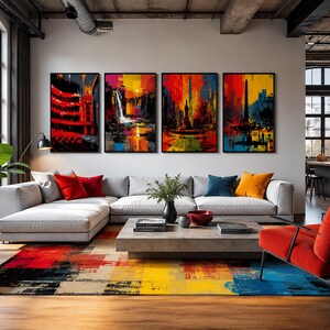 Op de afbeelding: Een woonkamer met een lichtgrijze hoekbank met rode, blauwe en oranje sierkussens, een betonnen salontafel, een rode fauteuil en een groot vloerkleed met een veelkleurig abstract patroon. Vier ingelijste schilderijen hangen aan de muur.