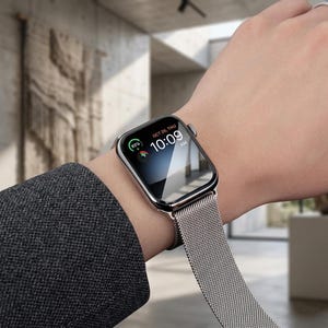May include: A silver smartwatch with a rectangular screen displaying the time 10:09 AM, the date OCT 26, THU, and an 86% battery charge icon. The device features a polished metallic frame and a fine silver-toned stainless steel mesh Milanese loop band.