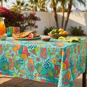 May include: A turquoise tablecloth with a colorful cocktail design, set for a poolside gathering. The table is laden with drinks, snacks, and fruit. A person walks by the pool in the background.