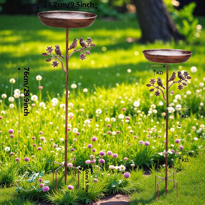 May include: Two bronze-colored bird feeders with a decorative tree branch design. Each feeder has a circular bowl, 9.5 inches in diameter, and stands 29.9 inches tall. The feeders are placed in a grassy garden setting.