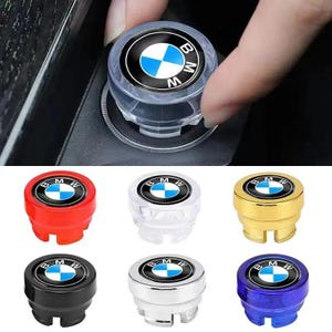 May include: A collection of BMW car accessories, including a clear plastic cap being installed and several colored caps in red, clear, gold, black, silver, and blue. Each cap features the BMW logo.