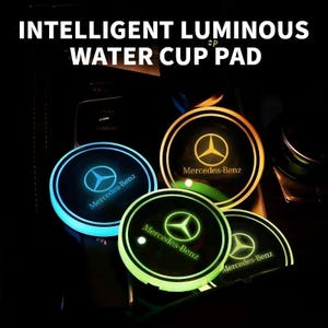 May include: Illuminated car cup holder pads with the text "INTELLIGENT LUMINOUS WATER CUP PAD" and the Mercedes-Benz logo. The pads glow in blue, green, and yellow. The pads are round and fit into a car's cup holder.