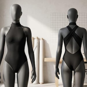 May include: A black bodysuit displayed on a mannequin. The bodysuit features a high neckline and a halter design in the front. The back has a crisscross strap design, revealing the back. The mannequin is in a studio setting.