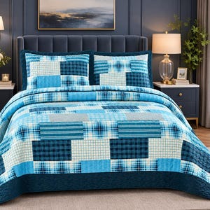 May include: A blue patchwork quilt set featuring a variety of rectangular patterns in shades of navy, sky blue, and white. The bedding includes a quilted bedspread and two matching pillow shams, all displaying a mix of plaid and grid designs.