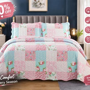 May include: A patchwork quilt set featuring a repeating pattern of pink roses, light blue floral motifs, and pink and white gingham squares. The bedding includes two matching pillow shams with scalloped edges and a coordinating bedspread.