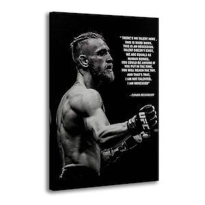 May include: A black and white canvas print featuring a side profile of a bearded fighter wearing UFC gloves. The text reads: THERE'S NO TALENT HERE, THIS IS HARD WORK. THIS IS AN OBSESSION. TALENT DOESN'T EXIST, WE ARE EQUALS AS HUMAN BEINGS.