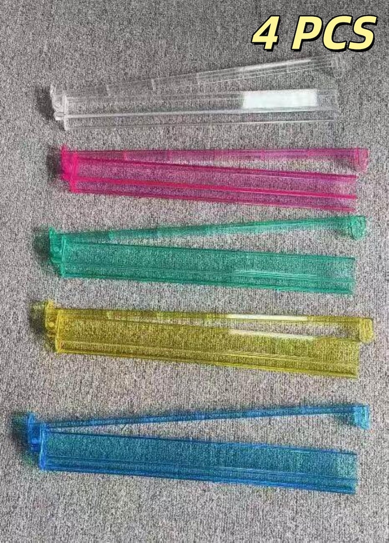 Puede incluir: Vista cenital de cinco cierres de bolsas de pl&aacute;stico en varios colores: transparente, rosa, verde, amarillo y azul. El texto "4 PCS" es visible. Estos cierres est&aacute;n dise&ntilde;ados para mantener los alimentos frescos.