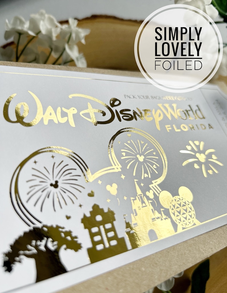 May include: Gold foil sticker featuring the text "Walt Disney World Florida" and a Mickey Mouse silhouette with images of fireworks, Cinderella's Castle, and the Spaceship Earth. The sticker has the text "Simply Lovely Foiled" above it.