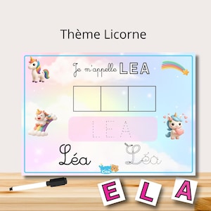 Peut inclure: Un tableau d'apprentissage coloré avec le texte "Thème Licorne" et "Je m'appelle LEA". Le tableau présente des illustrations de licornes, un arc-en-ciel et les lettres E, L et A. Comprend un marqueur noir et des lettres.