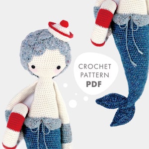 May include: Crochet pattern PDF for a mermaid doll with a blue tail, white body, and red and white life preserver. The doll is wearing a blue and white striped sailor hat.
