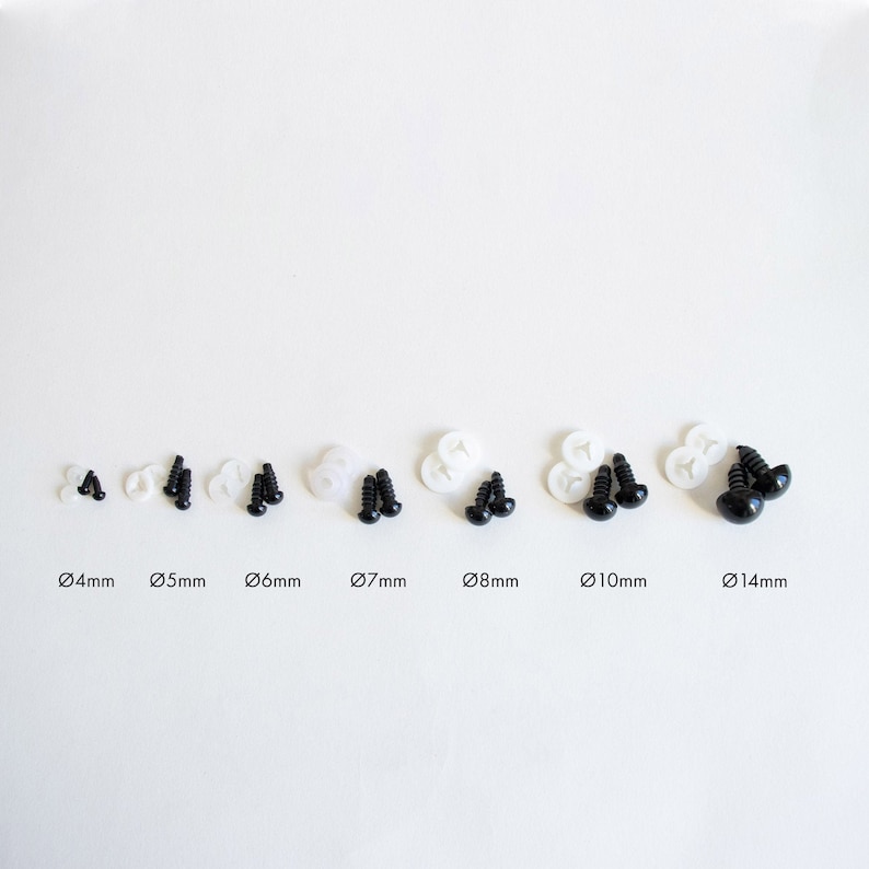 May include: Assortment of black plastic safety eyes for crafts, ranging in size from 4mm to 14mm. Each eye is paired with a white plastic washer.