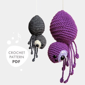 May include: Crochet pattern PDF for making two amigurumi spiders, one purple and one gray. The spiders have eight legs and are hanging from the ceiling.
