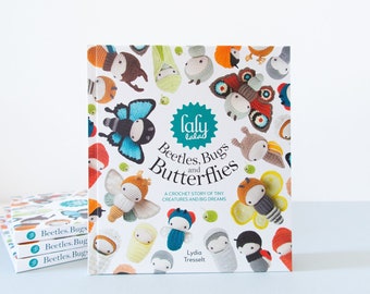 May include: A book titled "Beetles, Bugs and Butterflies" by laly lalad. The book cover features a colorful illustration of crocheted insects and butterflies.