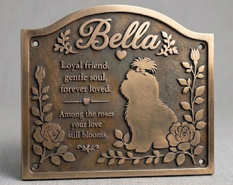 May include: A bronze-colored rectangular memorial plaque with an arched top, featuring the name Bella, a silhouette of a dog, and the text: Loyal friend, gentle soul, forever loved. Among the roses your love still blooms.