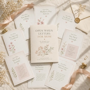 May include: A collection of cream-colored cards titled Open When Letters for Mom, featuring floral illustrations and text prompts like You Need a Hug, You Miss My Childhood, and You Need to Laugh, arranged with a matching envelope and ribbon.