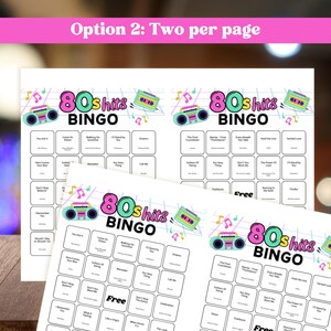 May include: White paper sheets with "80s Hits BINGO" game boards. Each board features a retro boombox graphic and song titles. The text "Option 2: Two per page" is at the top in pink.