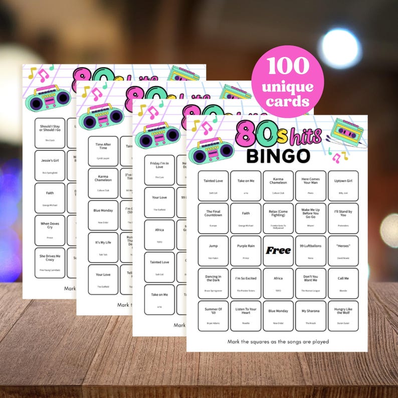 May include: Four sheets of 80s Hits Bingo cards with a pink circle that says "100 unique cards". Each card has a retro boombox graphic and song titles. The Bingo cards are on a wooden surface.
