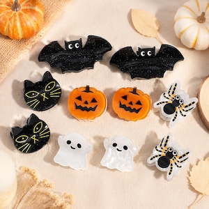 Adorabili mini fermagli per capelli a forma di mostro, tra cui un fantasma sorridente e un ragno a strisce, per bambini.