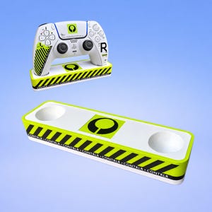May include: A white and neon green gaming controller stand featuring black diagonal hazard stripes and the text CONTRLR repeated along the base. A matching white gaming controller with a neon green logo and black accents rests on a similar stand.