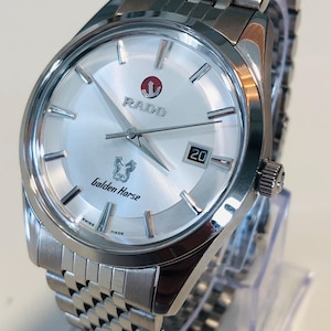 May include: Silver-toned Rado Golden Horse watch with a silver dial and a date display at the 3 o'clock position. The watch features a stainless steel band and a round face. The watch is Swiss made.
