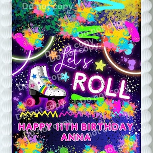 May include: A colorful birthday cake with a neon roller skate design. The cake features the words "Let's ROLL" and "Happy 11th Birthday Anna" with vibrant paint splatters and a rainbow accent.