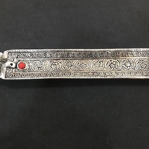 May include: A handmade, wooden serving tray with a natural finish. The tray features a rectangular shape with rounded corners and two carved handles. The wood grain is visible, adding to its rustic charm. Dimensions are approximately 16 inches long and 10 inches wide.
