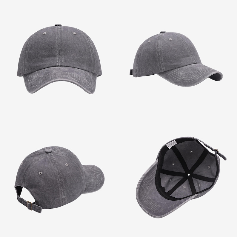 May include: A charcoal gray baseball cap with a washed-out finish, featuring a curved brim, a button on the crown, and an adjustable metal buckle strap at the back. The interior shows black seam tape and a white fabric label on the inner band.