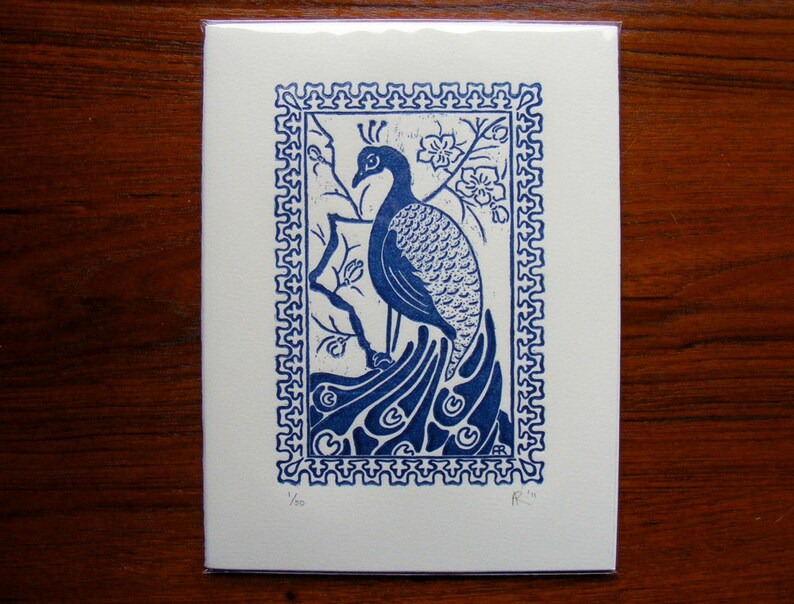 May include: Blue and white print of a peacock with a decorative border. The print is numbered 1/50 and signed "R.W."