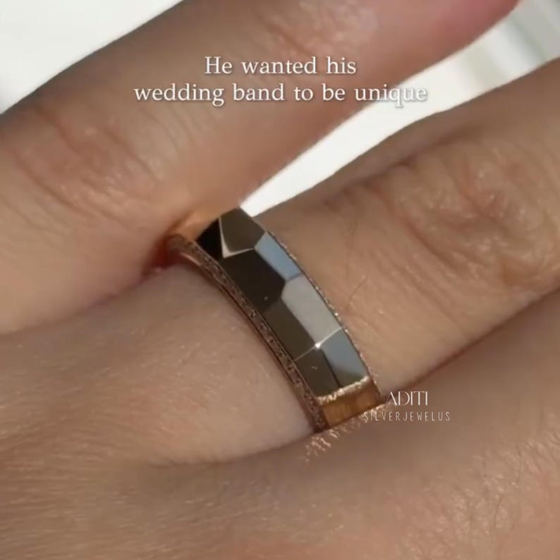 May include: Modern faceted men's wedding band crafted in solid 14K yellow gold featuring a geometric exterior and pavé-set lab diamonds along one side of the band. The text "BY ADITISILVERJEWELUS" is visible at the bottom.
