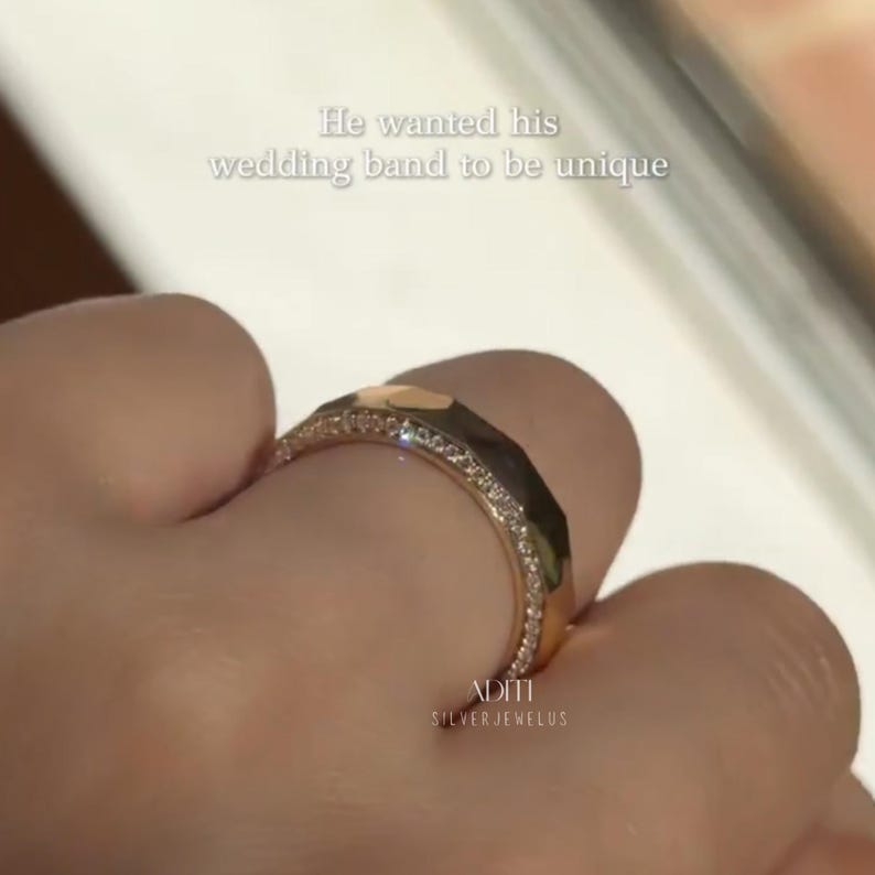 May include: Modern faceted men's wedding band crafted in solid 14K yellow gold featuring a geometric exterior and pavé-set lab diamonds along one side of the band. The text "BY ADITISILVERJEWELUS" is visible at the bottom.