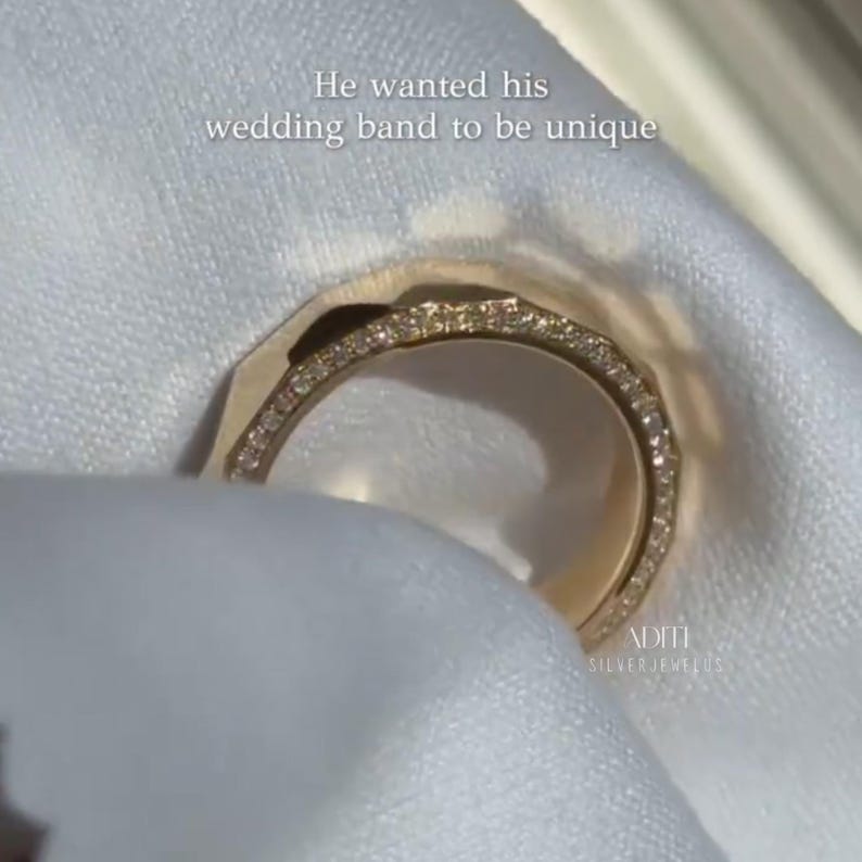 May include: Modern faceted men's wedding band crafted in solid 14K yellow gold featuring a geometric exterior and pavé-set lab diamonds along one side of the band. The text "BY ADITISILVERJEWELUS" is visible at the bottom.