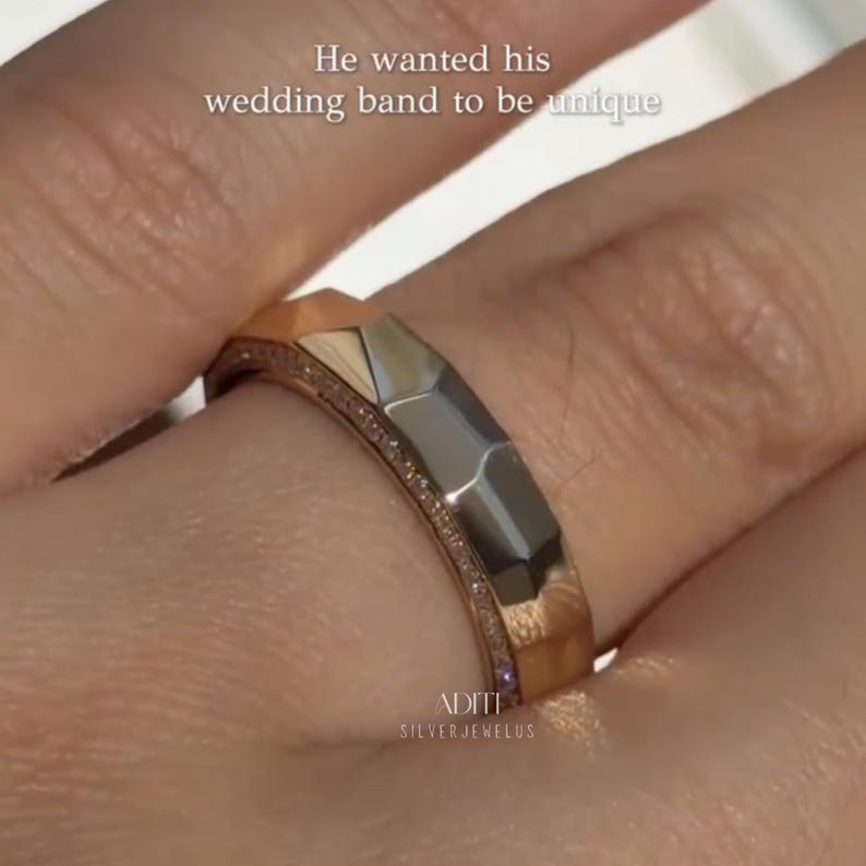 May include: Modern faceted men's wedding band crafted in solid 14K yellow gold featuring a geometric exterior and pavé-set lab diamonds along one side of the band. The text "BY ADITISILVERJEWELUS" is visible at the bottom.