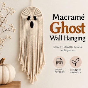 May include: A macramé ghost wall hanging made of off-white cotton rope with black felt eyes and mouth. The text reads Macramé Ghost Wall Hanging, Step-by-Step DIY Tutorial for Beginners, Digital Pattern, and Beginner Friendly.