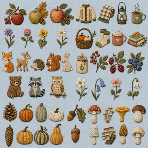 May include: A collection of embroidered patches featuring autumn themes including apples, pumpkins, woodland animals like foxes and owls, mushrooms, pinecones, flowers, cozy sweaters, mugs, and books arranged on a light blue fabric background.