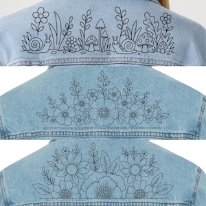 May include: A light blue denim jacket featuring three distinct back designs in black line art. The top design shows snails, mushrooms, and flowers. The middle design displays a floral arrangement. The bottom design features large flowers and leaves.